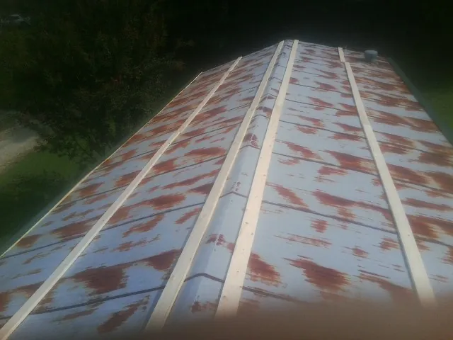 Rusted metal roof panels with new wood purlins before replacement — Storm Damage Roof Repair in Upperstrasburg by Roofing Brothers