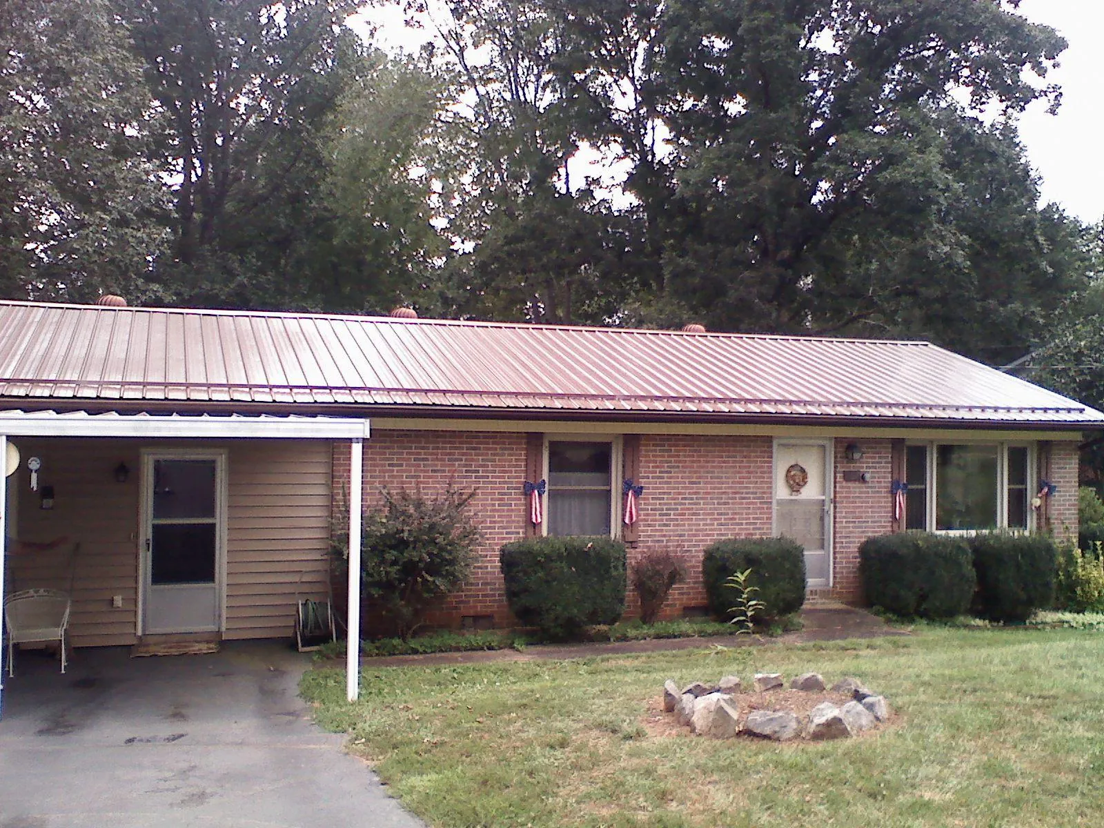 Bronze metal roof and carport on a brick ranch home — Roof Repair work by our crew in Upperstrasburg