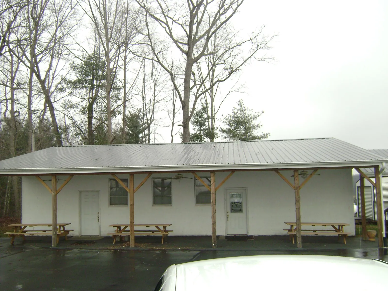 Gray metal roof over a block building with a timber post porch in Upperstrasburg